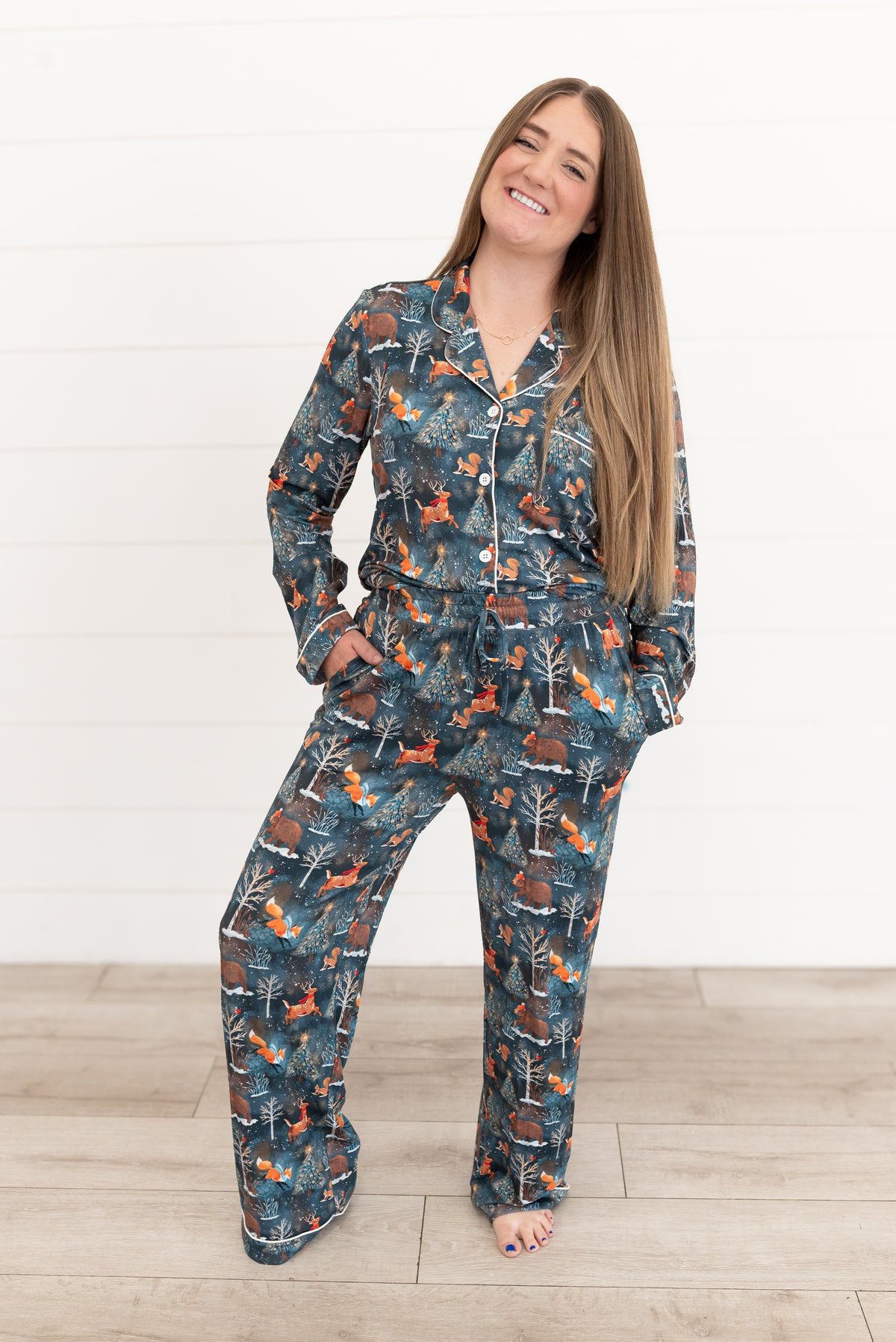 Woman laughing while standing in Woodland Wonder bamboo women's pajama pants and button-front shirt