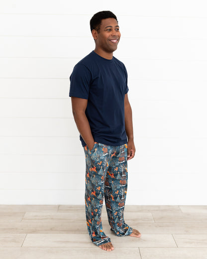 Man standing in Woodland Wonder bamboo men's pajama pants with a navy t-shirt