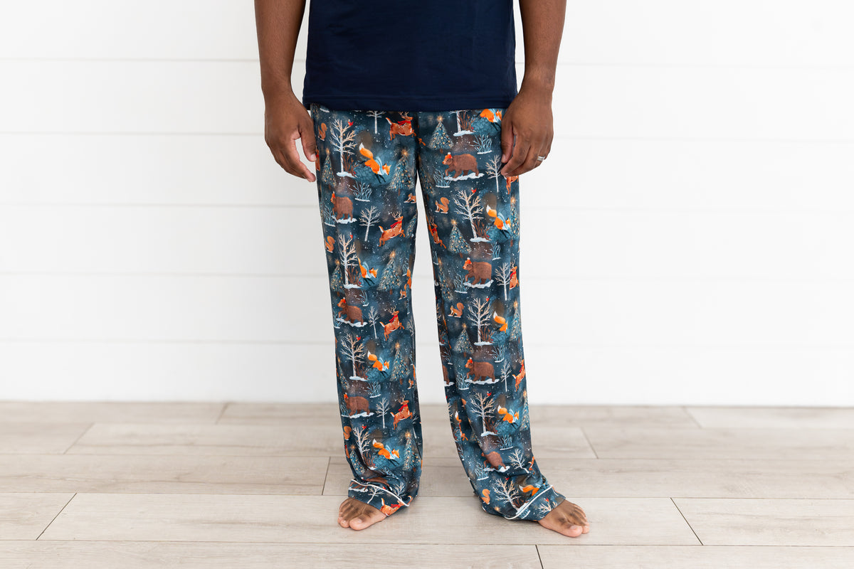 Man standing in a navy t-shirt and Woodland Wonder bamboo men's pajama pants