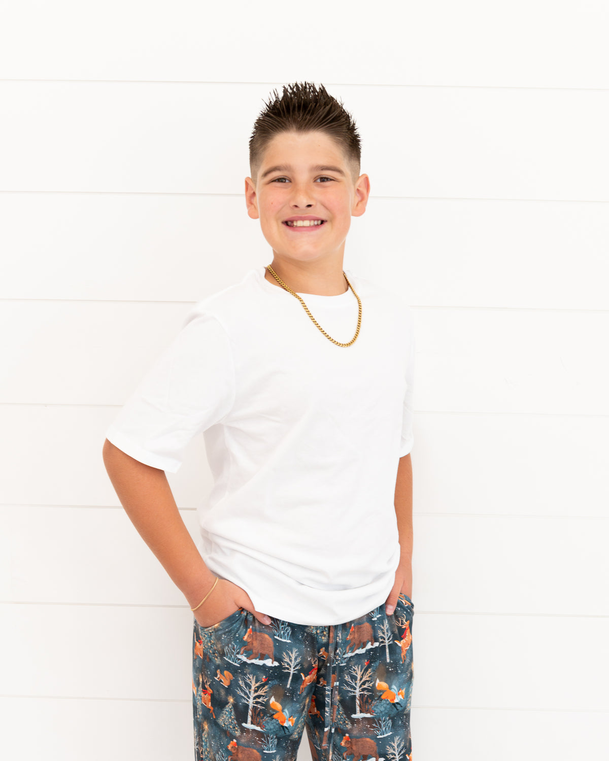Teen boy standing and smiling in Woodland Wonder bamboo pajama pants