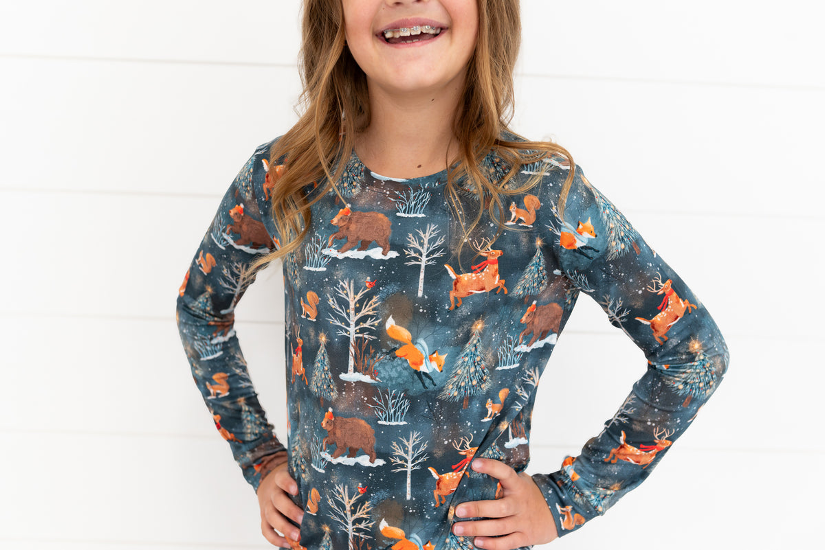 Teen girl with hands on hips wearing a Woodland Wonder bamboo teen pajama top