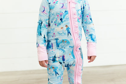 Baby Princess Pajama – The Wish Collection – on-model close-up of blue castle-print zip pajama with pink ruffled zipper