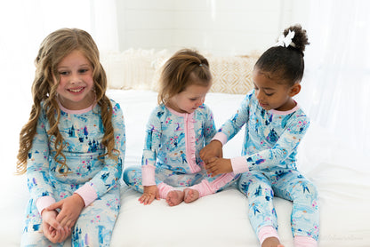 Two Piece Princess Pajama – The Wish Collection – on-model, three girls sitting on bed in matching blue castle-print pajamas