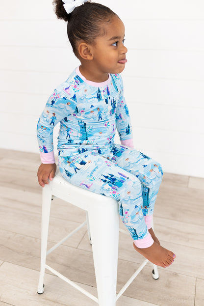 Two Piece Princess Pajama – The Wish Collection – on-model, child sitting on stool in blue castle-print pajamas
