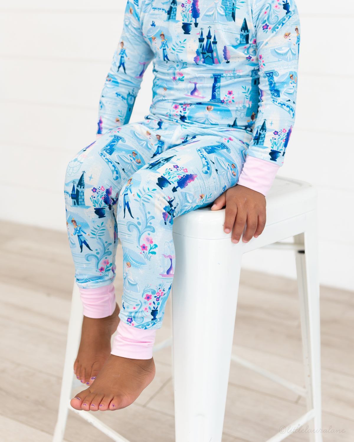 Two Piece Princess Pajama – The Wish Collection – on-model close-up of blue castle and glass-slipper print pajamas