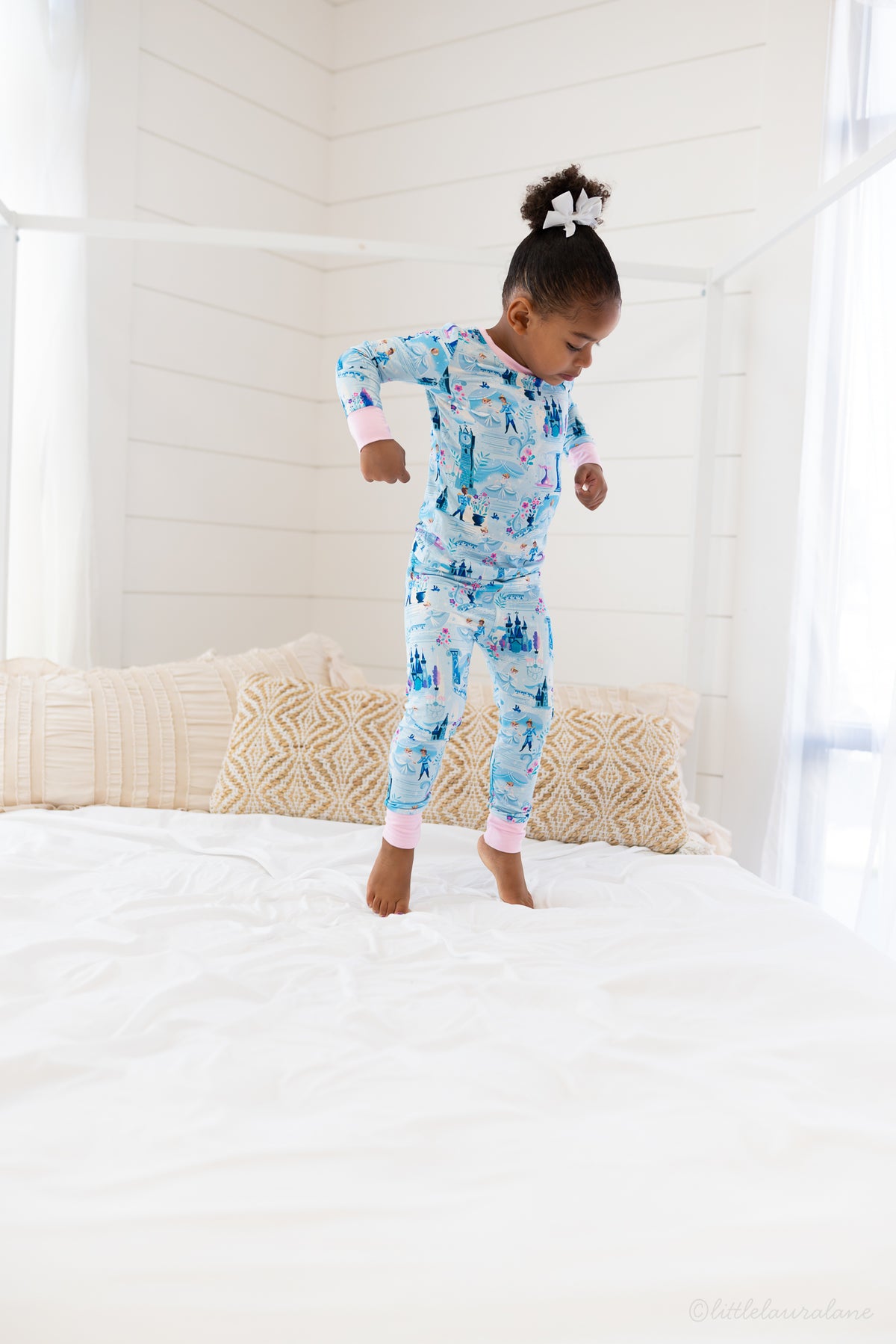 Two Piece Princess Pajama – The Wish Collection – on-model lifestyle, child jumping on bed in blue castle-print pajamas