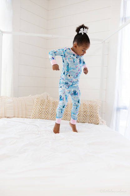 Two Piece Princess Pajama – The Wish Collection – on-model lifestyle, child jumping on bed in blue castle-print pajamas