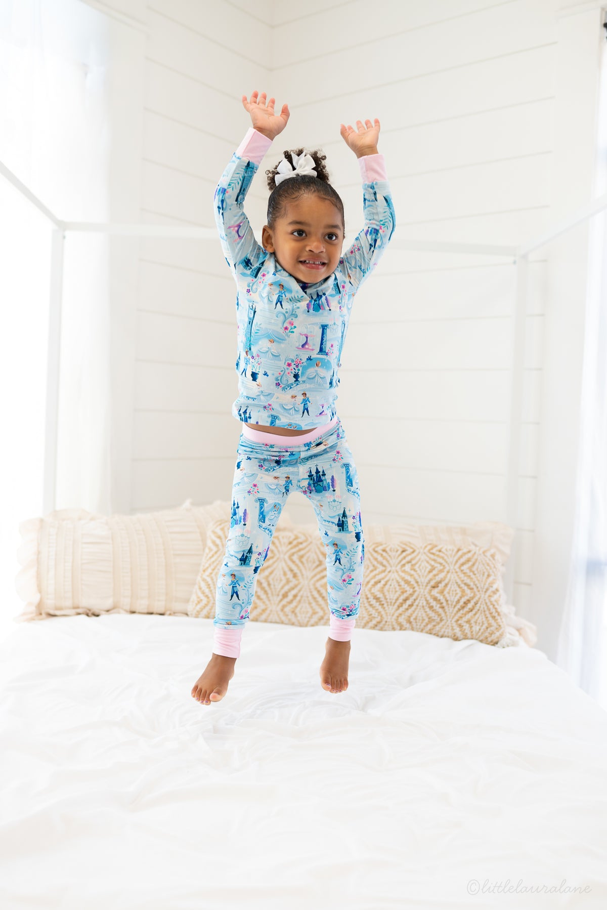 Two Piece Princess Pajama – The Wish Collection – on-model lifestyle, child jumping on bed in blue castle-print pajamas
