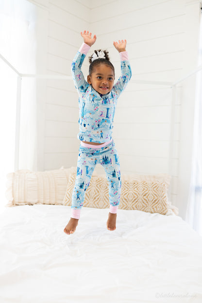 Two Piece Princess Pajama – The Wish Collection – on-model lifestyle, child jumping on bed in blue castle-print pajamas