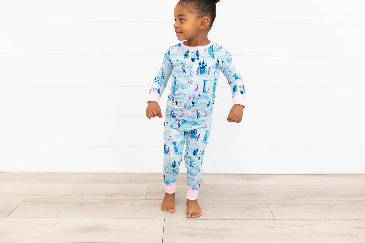 Two Piece Princess Pajama – The Wish Collection – on-model full-length front view, toddler in blue castle-print pajamas