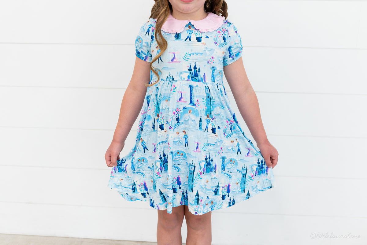 Girls Princess Dress with Shorts – The Wish Collection – close-up on-model of blue castle and glass-slipper print dress