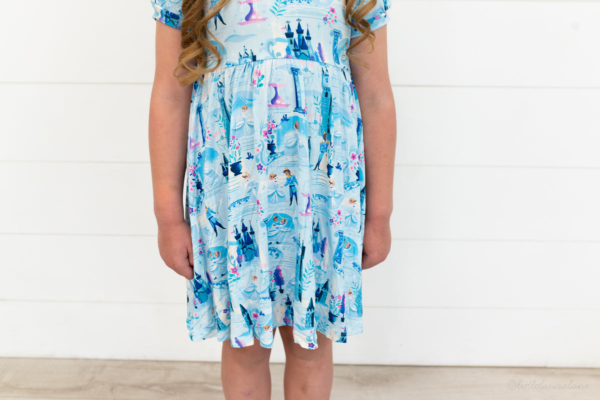 Girls Princess Dress with Shorts – The Wish Collection – close-up on-model of blue castle and glass-slipper print dress