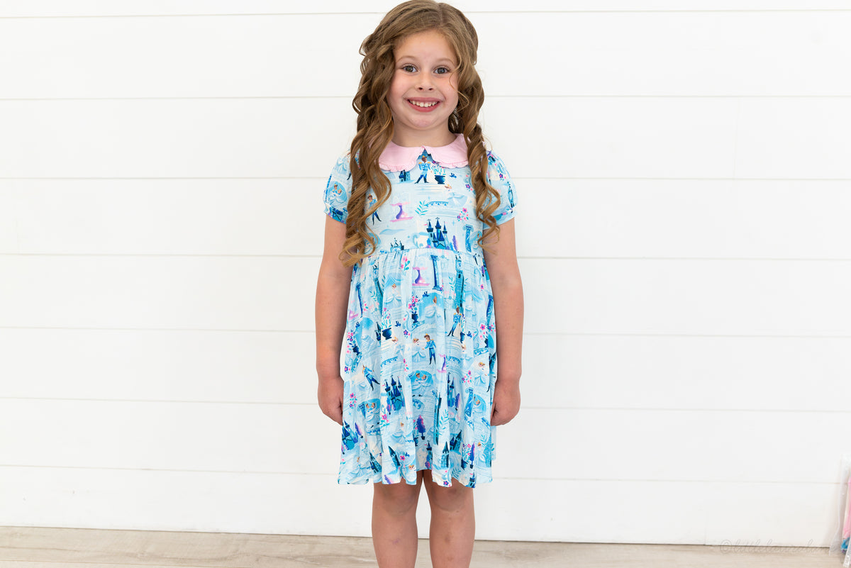 Girls Princess Dress with Shorts – The Wish Collection – on-model front view, blue castle-print dress with pink collar