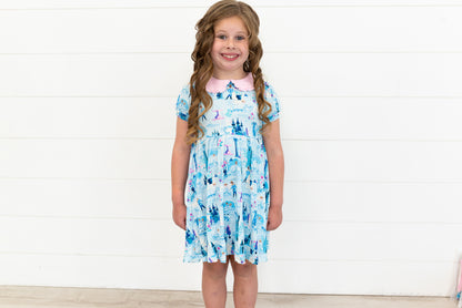 Girls Princess Dress with Shorts – The Wish Collection – on-model front view, blue castle-print dress with pink collar