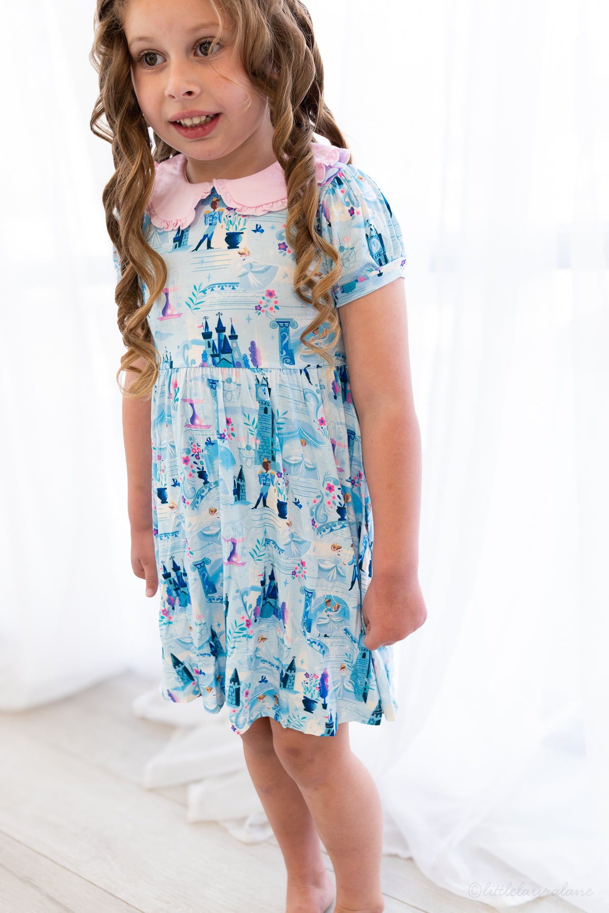 Girls Princess Dress with Shorts – The Wish Collection – on-model front view, blue castle-print dress with pink collar