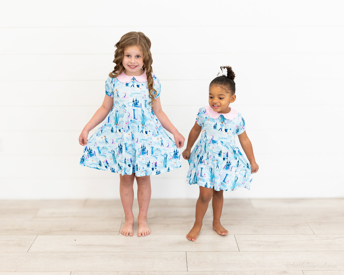 Girls Princess Dress with Shorts – The Wish Collection – two girls in matching blue castle-print dresses, front view