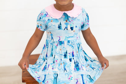 Girls Princess Dress with Shorts – The Wish Collection – close-up on-model of blue castle and glass-slipper print dress