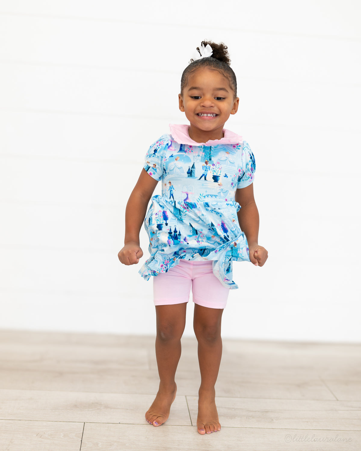 Girls Princess Dress with Shorts – The Wish Collection – on-model front view, blue castle-print dress with pink shorts
