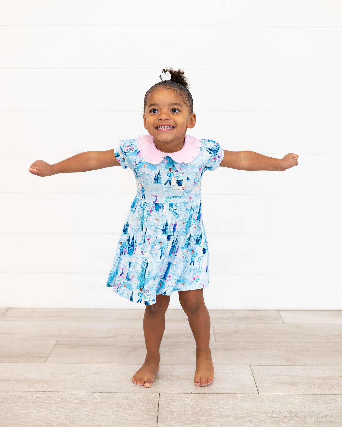 Girls Princess Dress with Shorts – The Wish Collection – on-model, girl with arms outstretched in blue castle-print dress