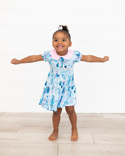 Girls Princess Dress with Shorts – The Wish Collection – on-model, girl with arms outstretched in blue castle-print dress