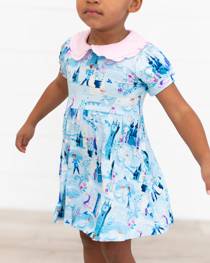 Girls Princess Dress with Shorts – The Wish Collection – close-up on-model of blue castle-print dress with pink collar