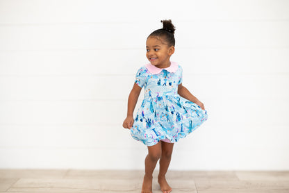 Girls Princess Dress with Shorts – The Wish Collection – on-model lifestyle, girl twirling in blue castle-print dress