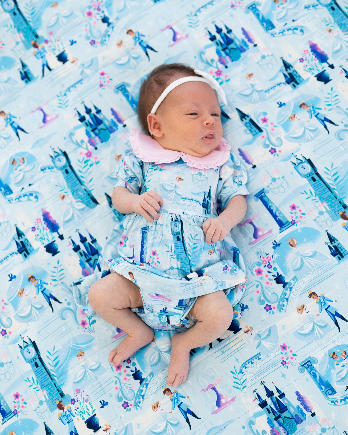 Baby Princess Dress – The Wish Collection – on-model, newborn on matching blue castle-print blanket and dress